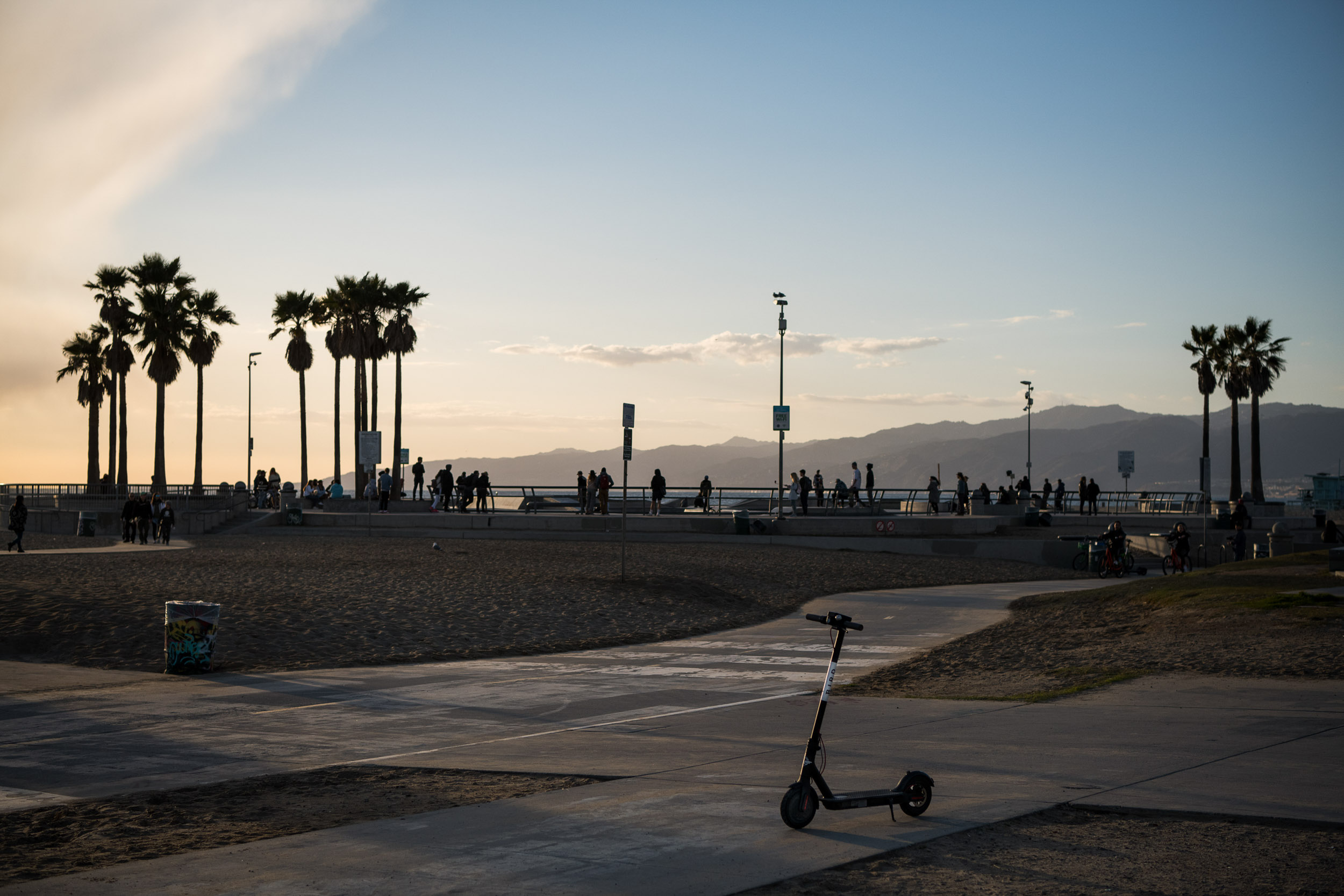 A Bird scooter on the Venice Beach bike path at sunset.