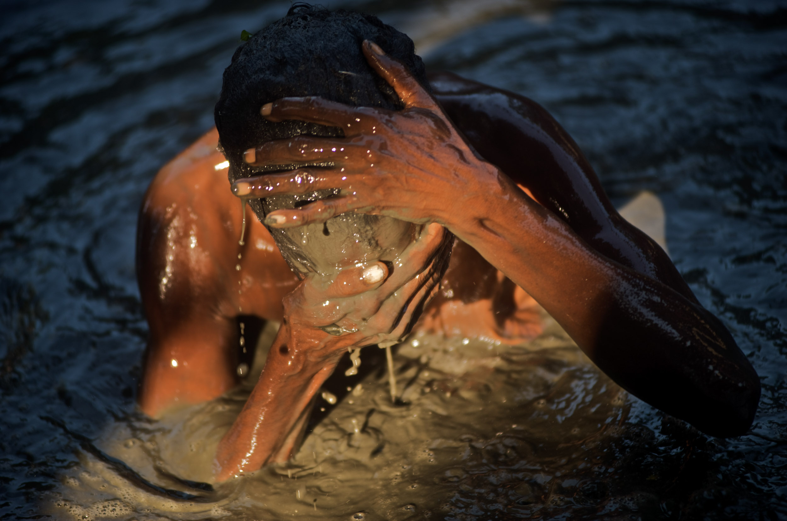 A woman bathes in the mud in St. Jacques