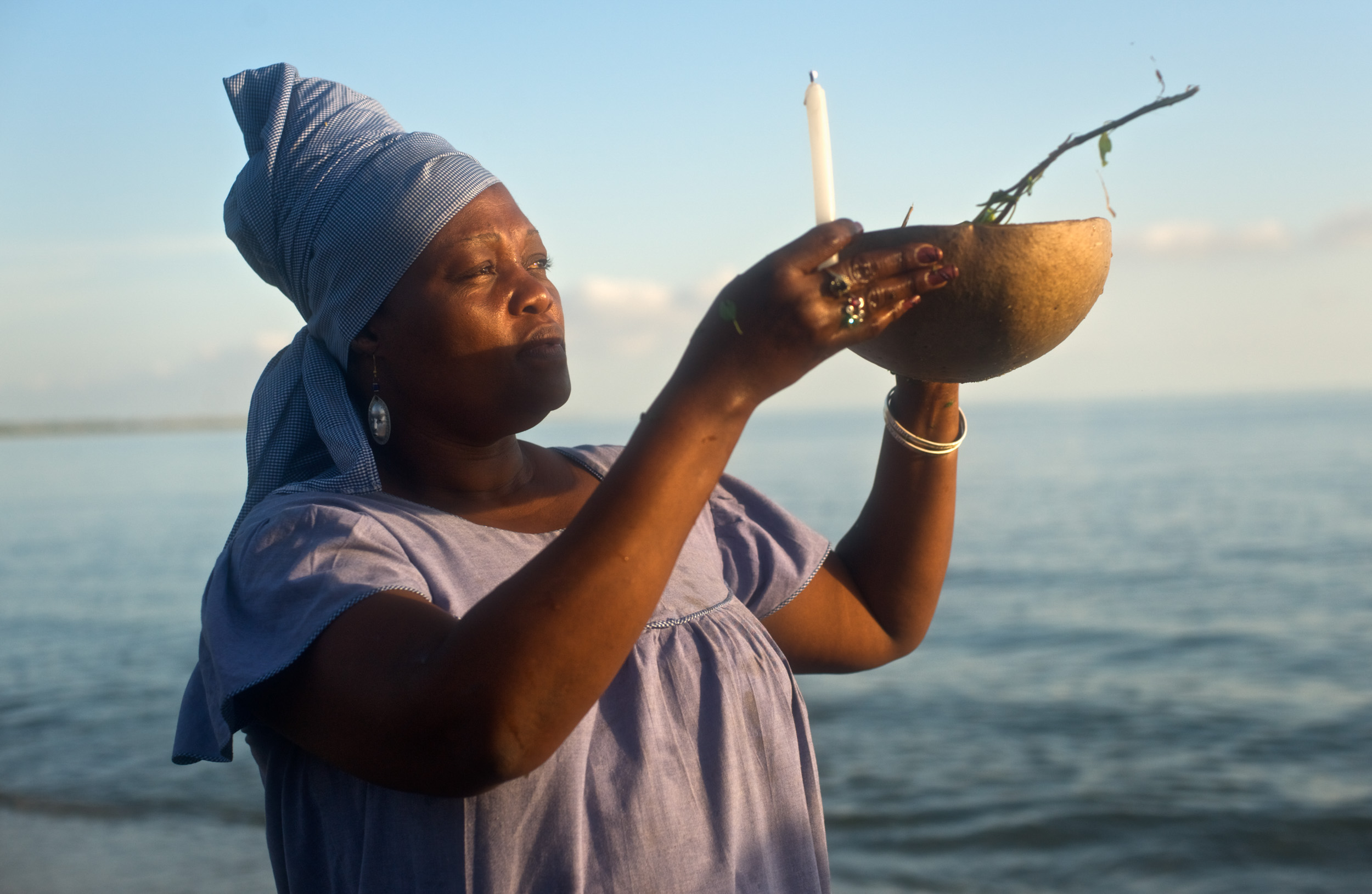 A priestess worships in the ocean during a voodou festival in Nord de Mer de Lemonade in Haiti.