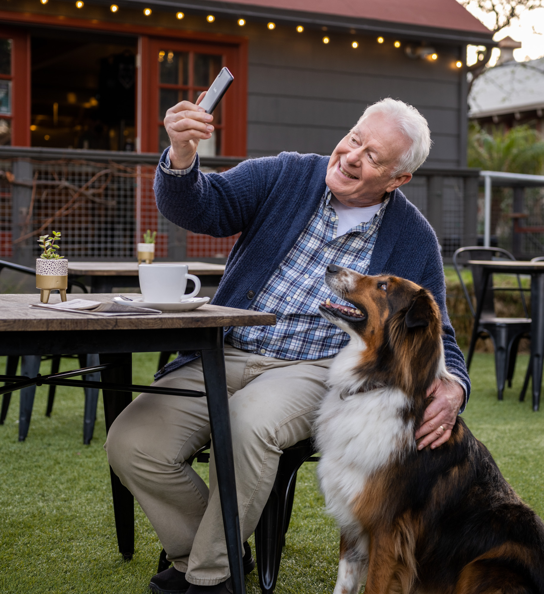 An older man takes a selfie with his dog in Santa Barbara, Calif.
