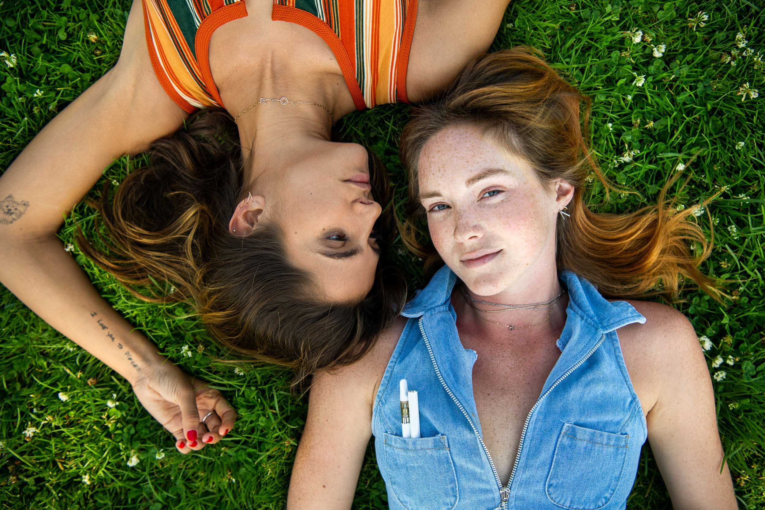 Female models lay in the grass for a recreational marijuana advertising campaign.