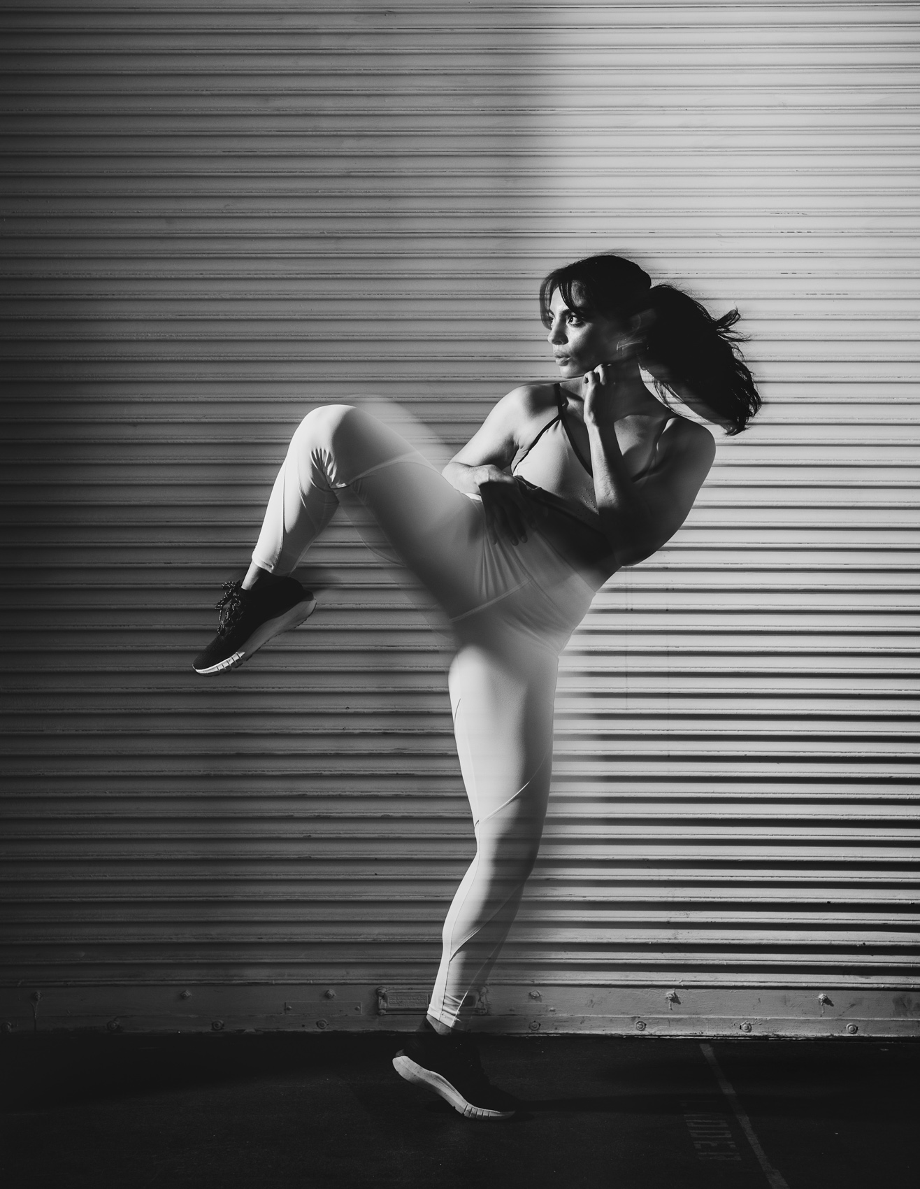 A female fitness model demonstrates taekwondo in a Los Angeles studio.