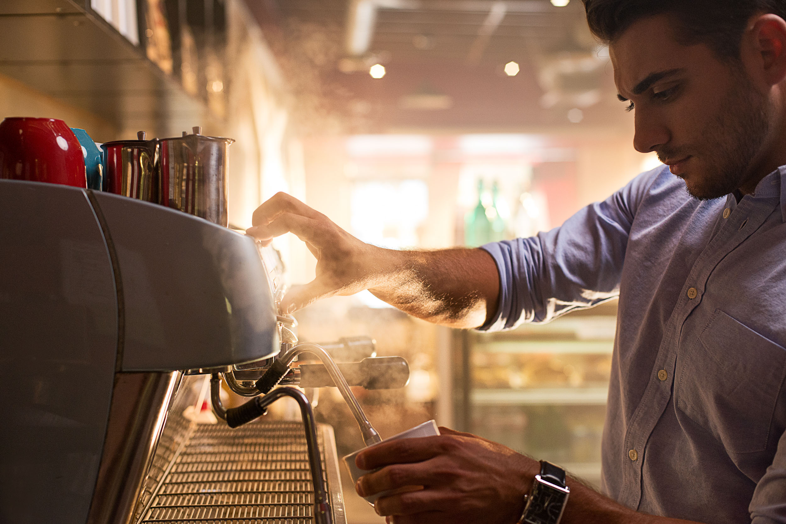 A man makes espresso in an advertisement for Kyocera phones.