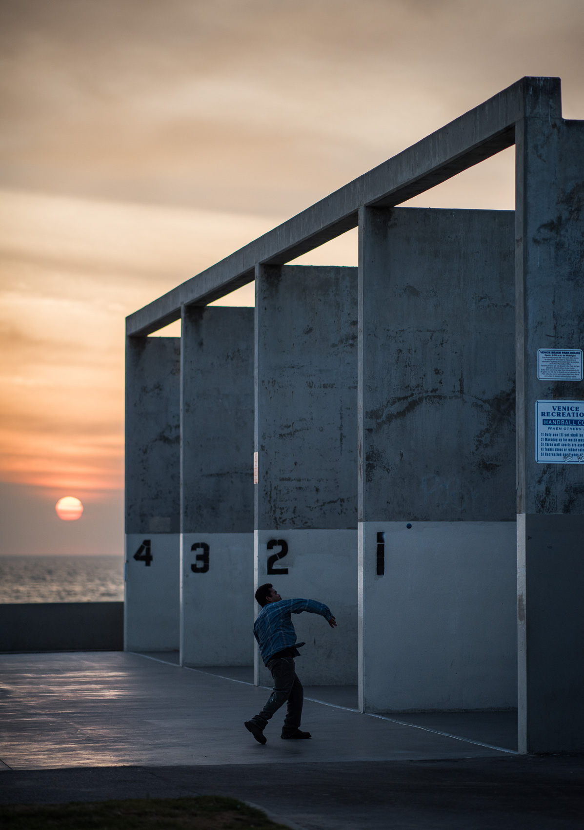 A man plays handball at sunset at the Venice Beach handball courts in Los Angeles.