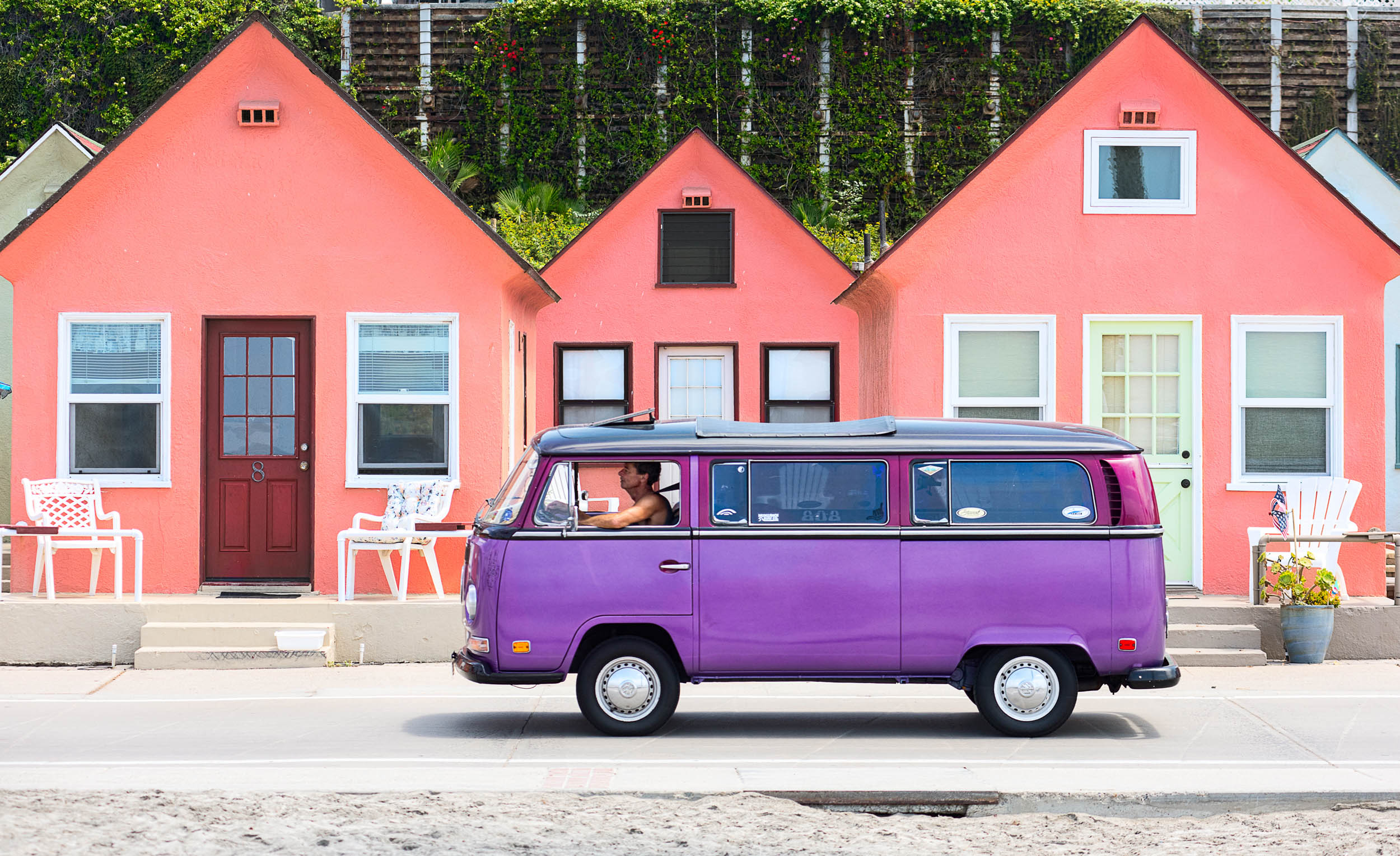 Los Angeles Editorial Photographer David Zentz - A purple VW van drives in front of Roberts Cottages in Oceanside, Calif.