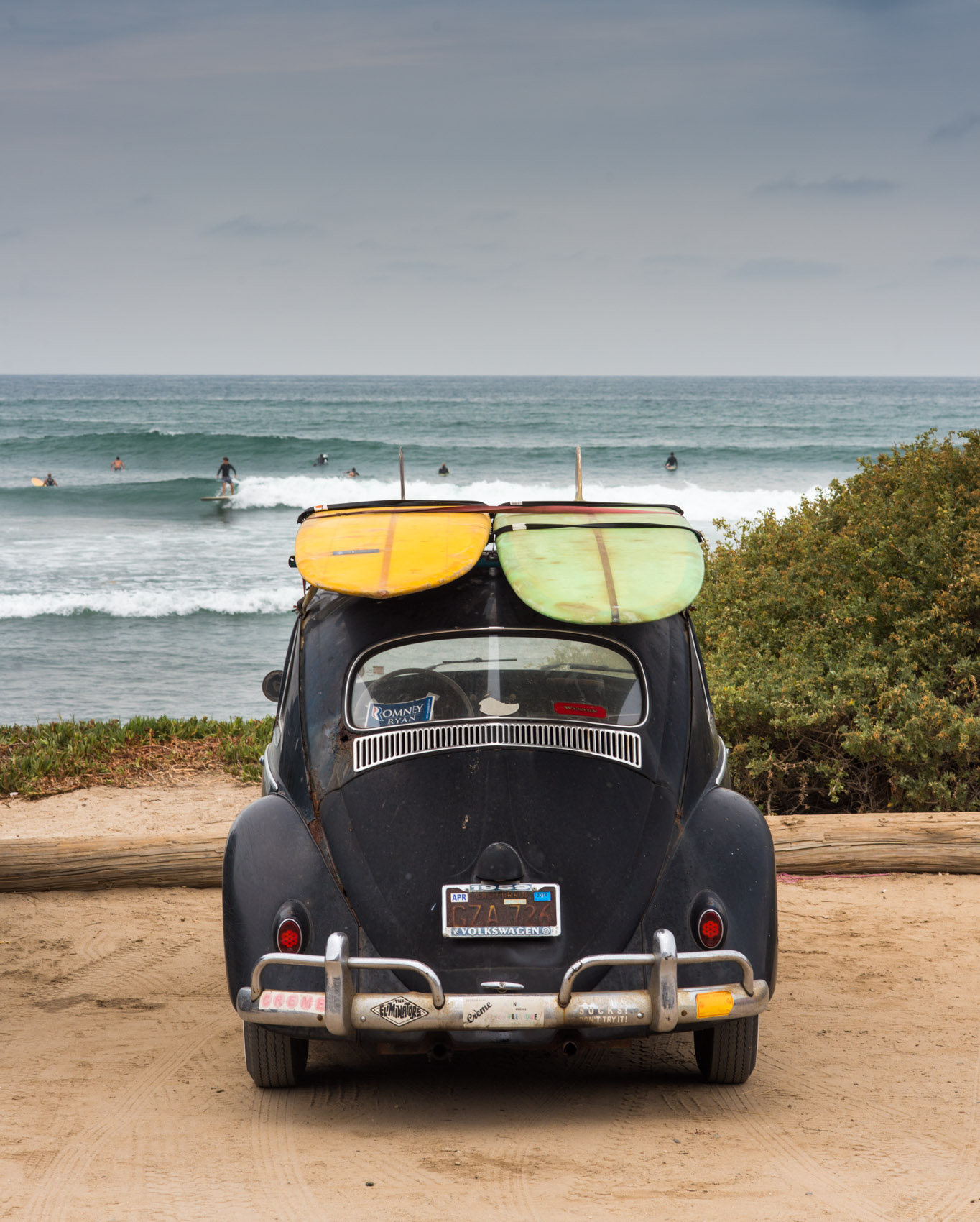 An old VW Beetle with surfboards on the roof at San Onofre State Beach, San Clemente, Calif.