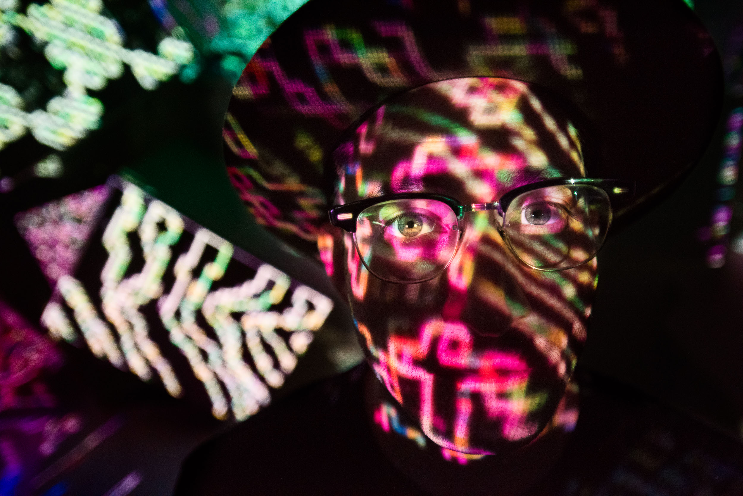 Portrait of artist Aaron Axelrod in front of projector lights in Hollywood.