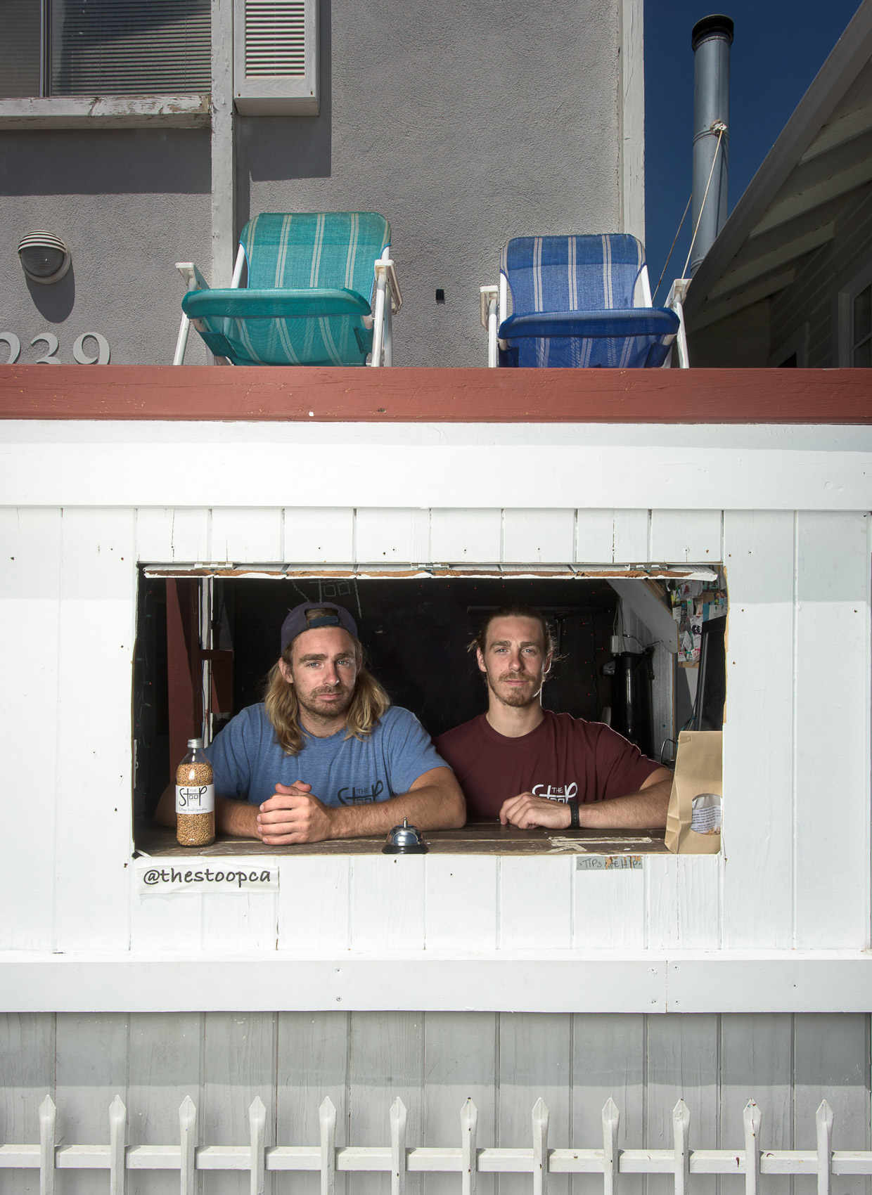 Portrait of two small business owners through a window in Venice Beach, Calif.