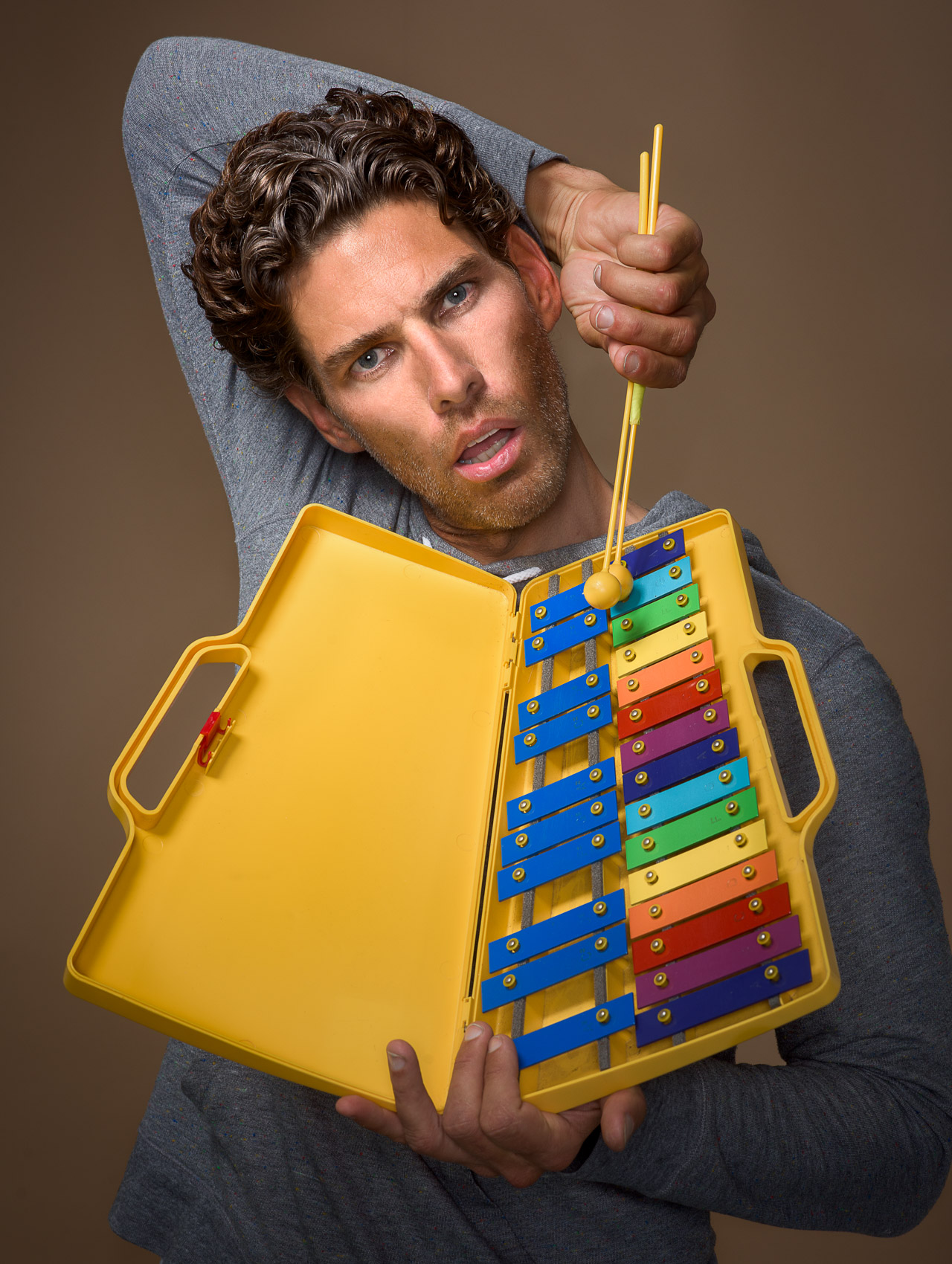 Humorous portrait of comedian Lachlan Patterson with a xylophone in Venice, Calif.