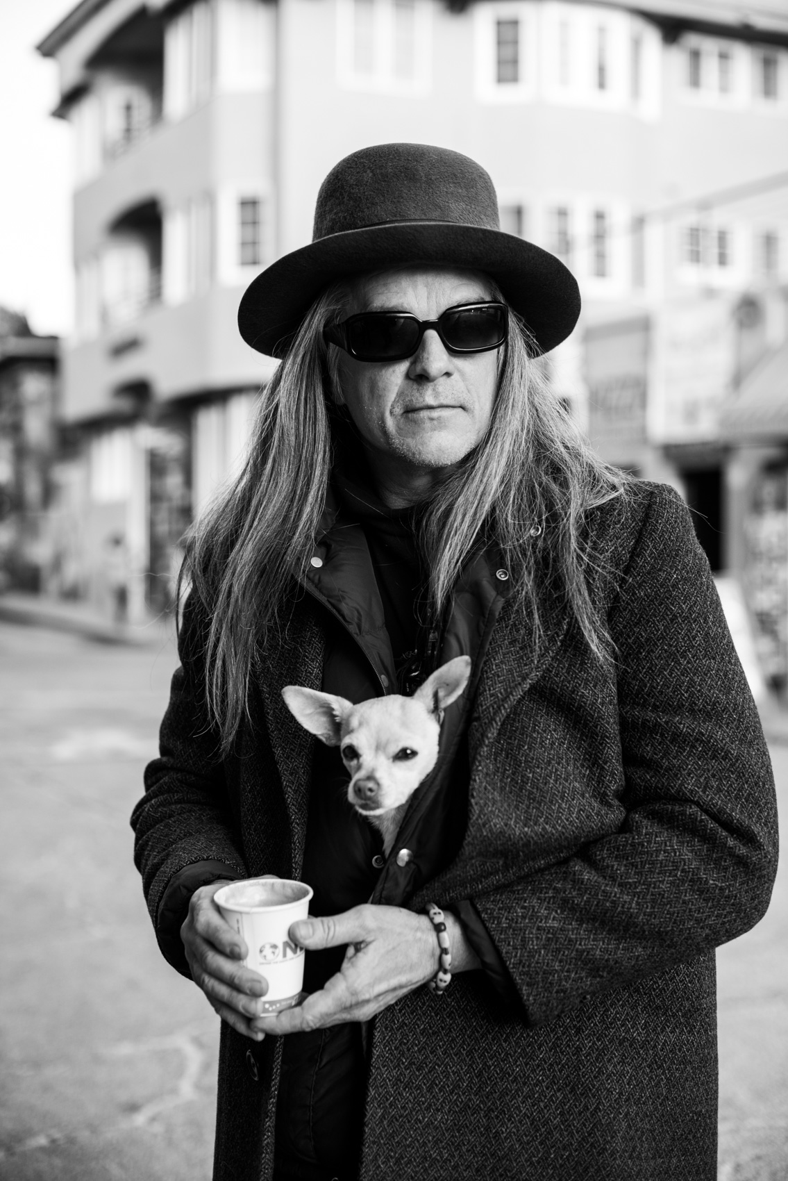 A street portrait of musician Mark Francis with his dog in Venice Beach, Calif.