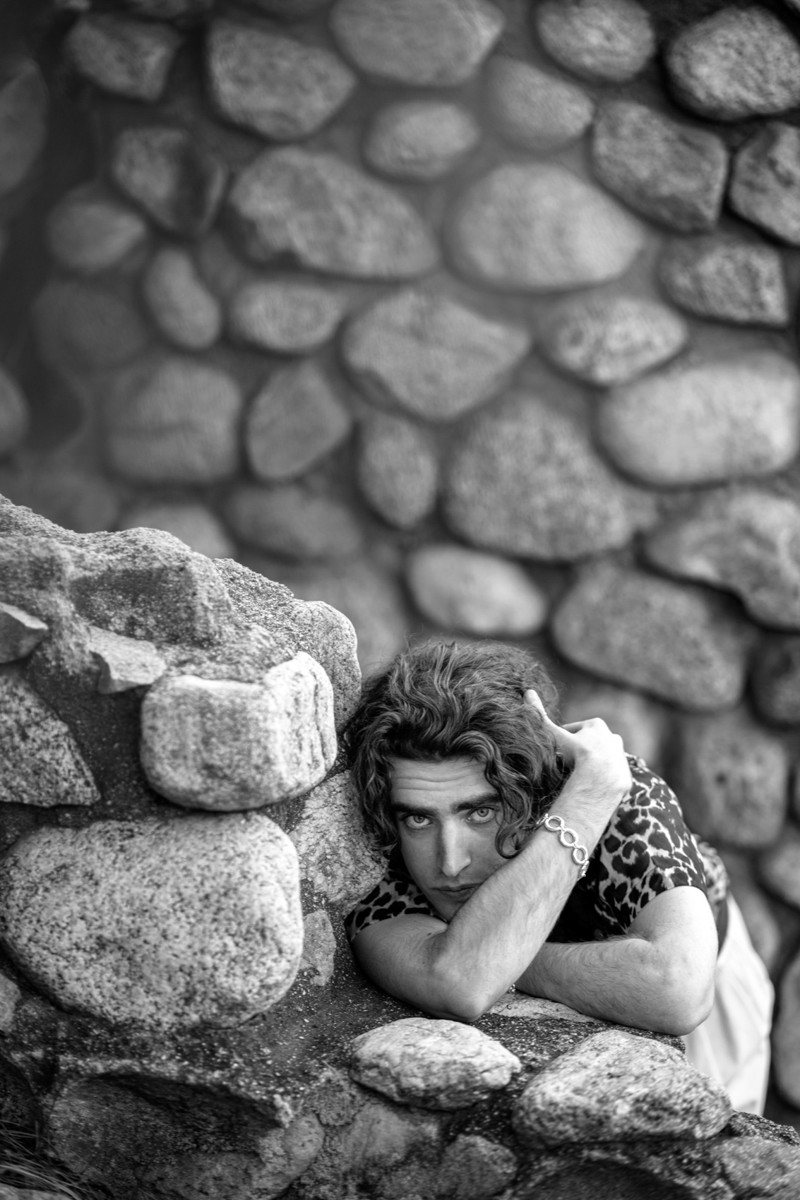 A model poses for a portrait against a stone wall in Los Angeles.