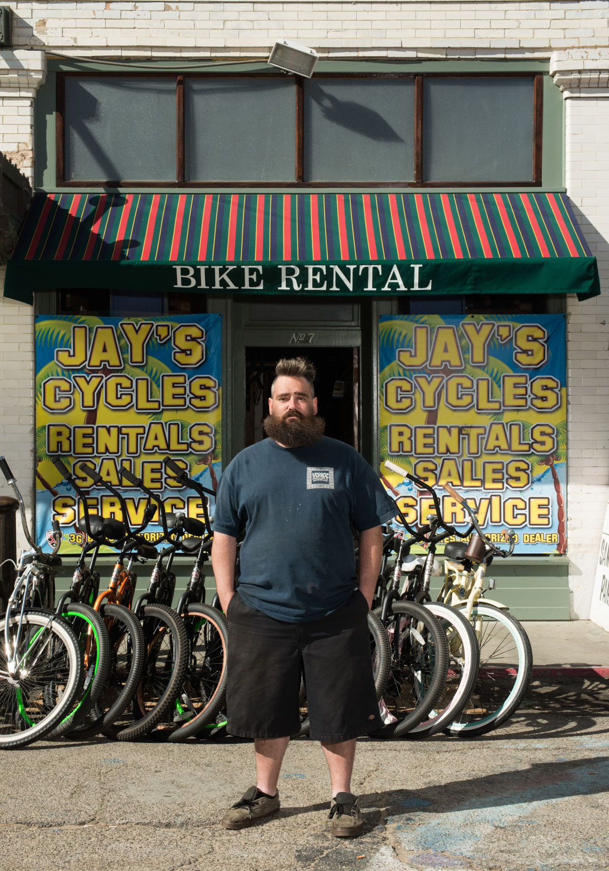 Portrait of man in front of bike shop in Venice, Calif.