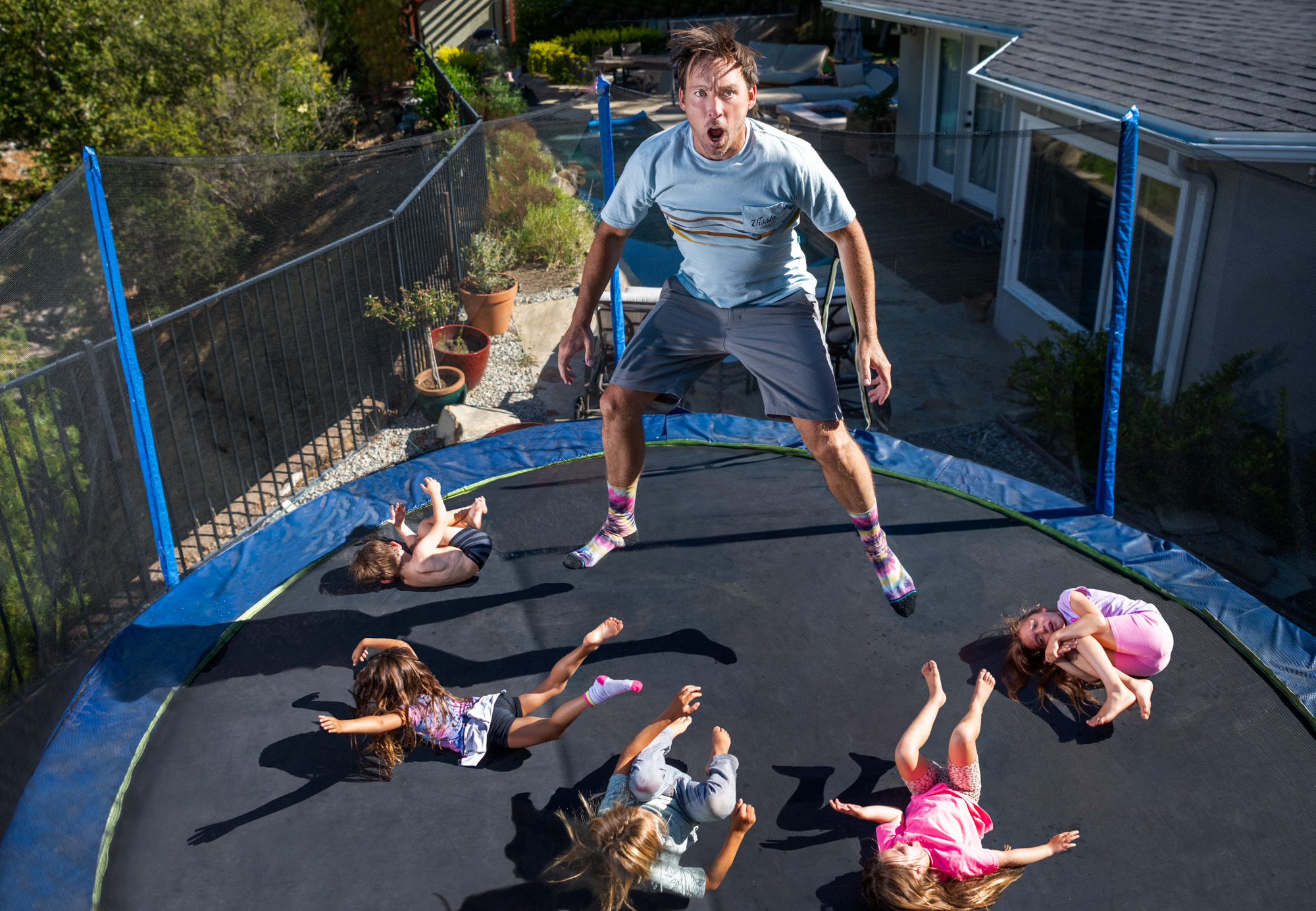 Humorous entertainment portrait of comedian Eddie Ifft on trampoline in Malibu, Calif.