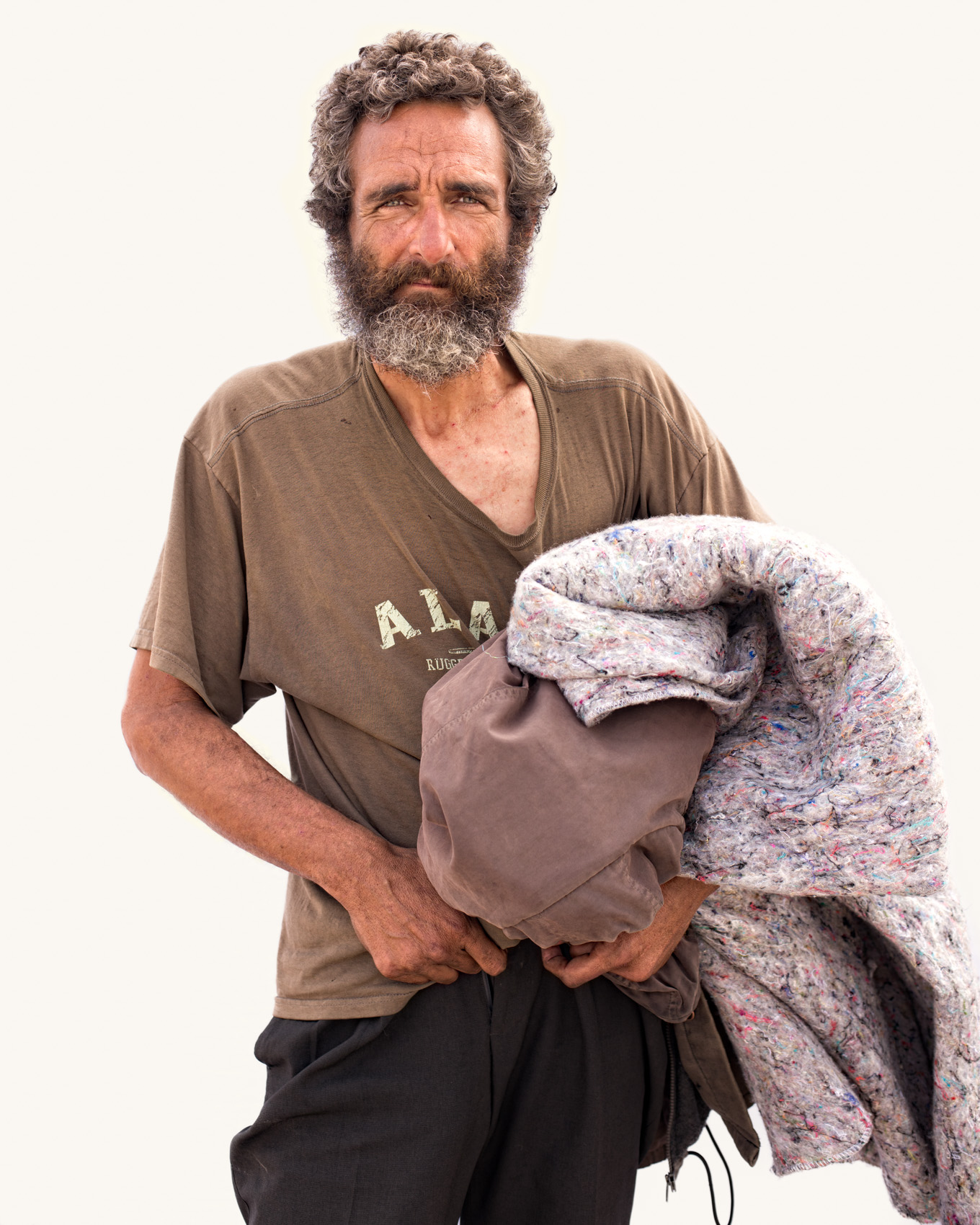 Homeless man Venice Beach street portrait series on white backdrop.