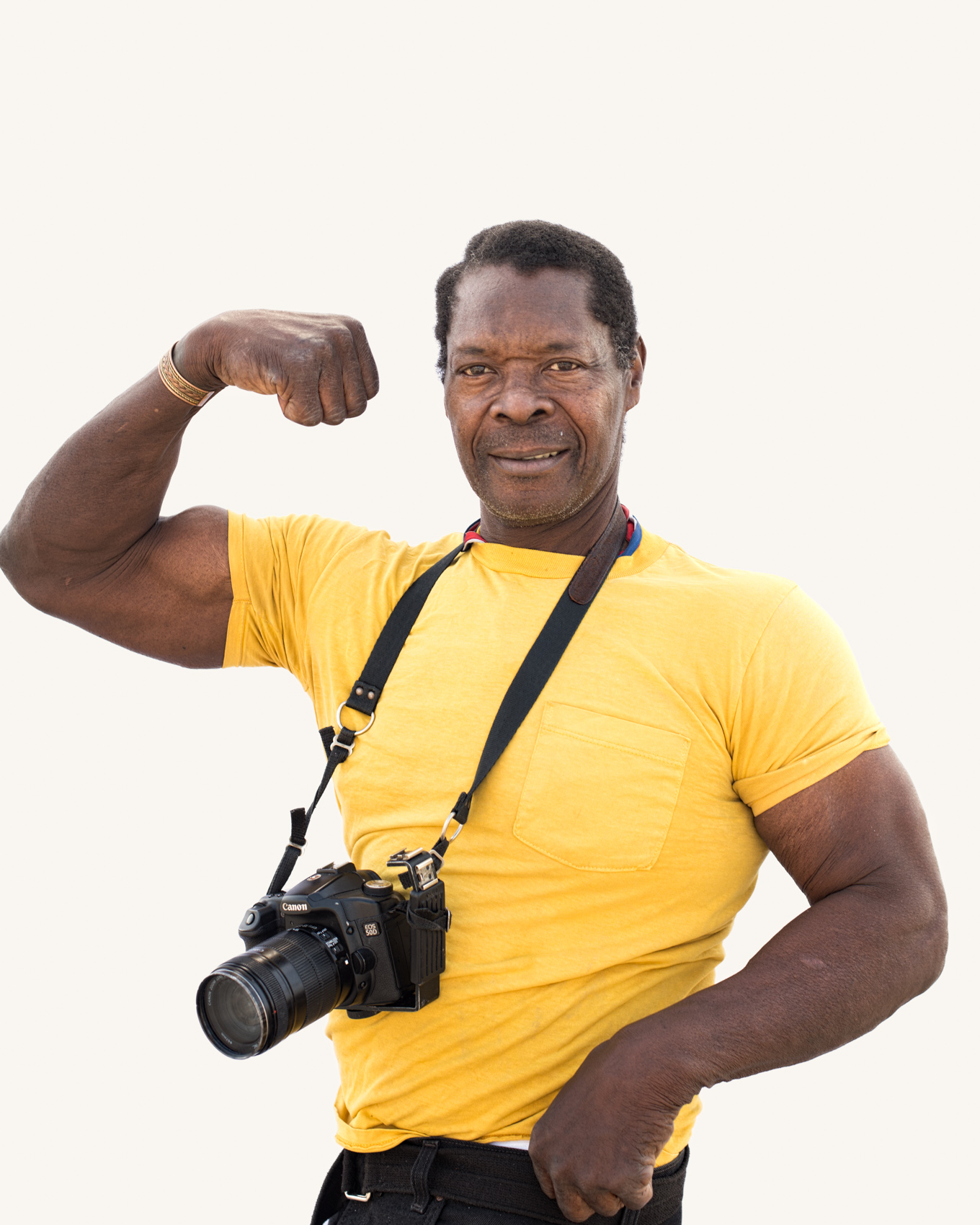 Flexing arm muscle Venice Beach street portrait series on white backdrop.