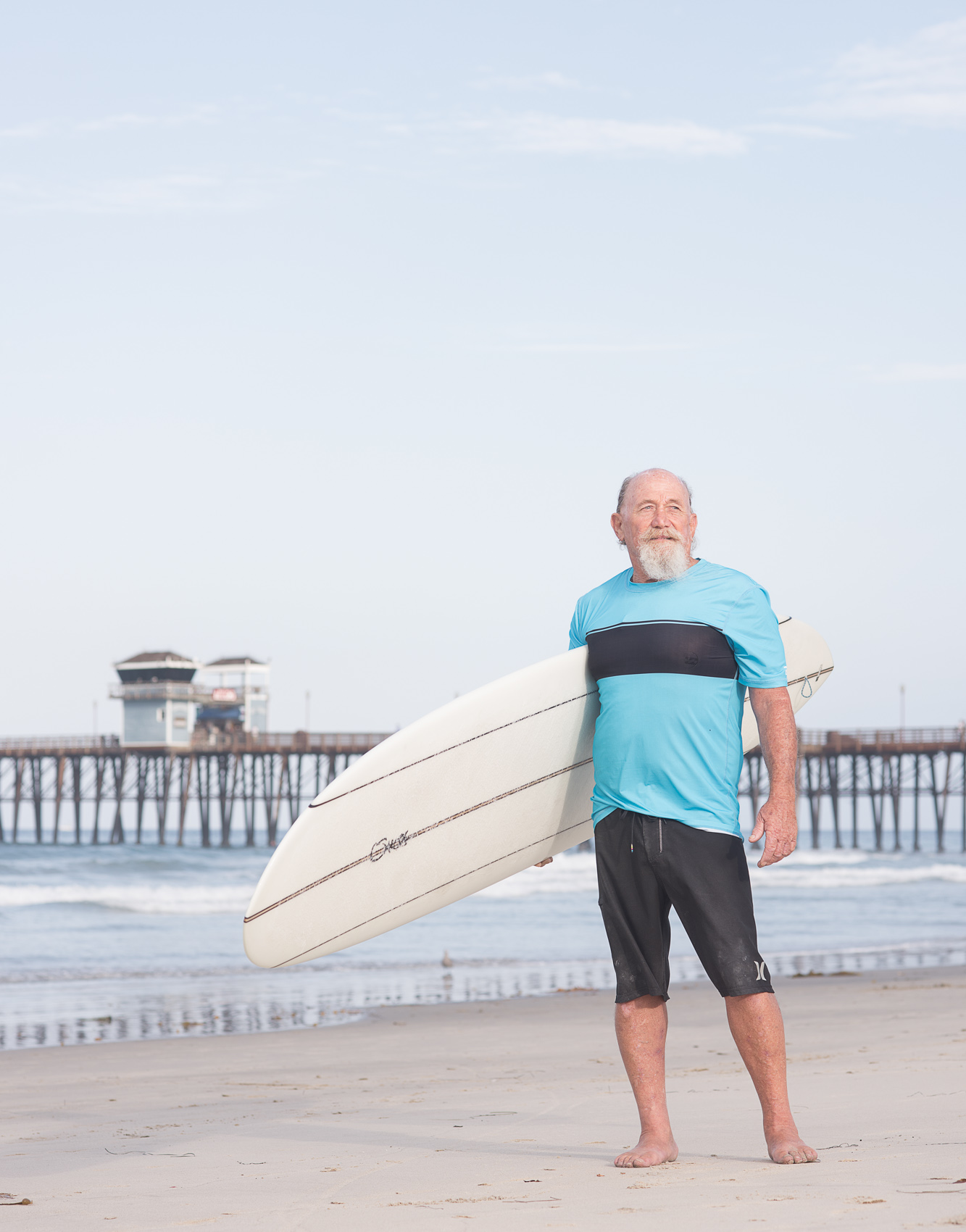 A senior surfer portrait on the beach in Oceanside, Calif.