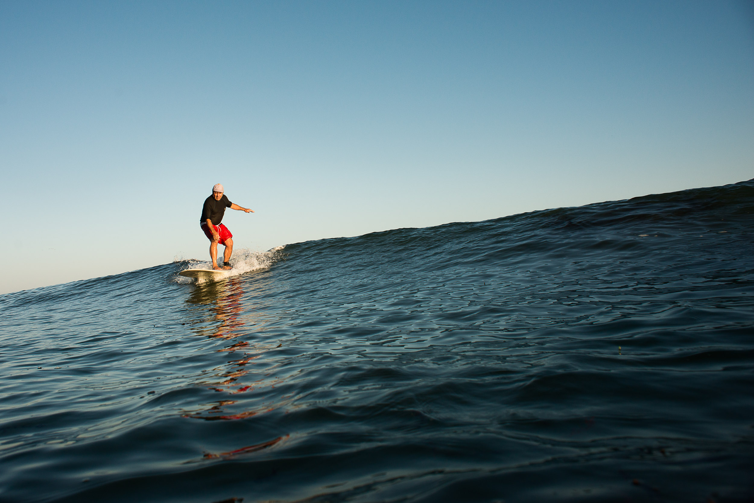 Active senior surfer Howard Boots McGhee catches a wave in Santa Cruz, Calif.
