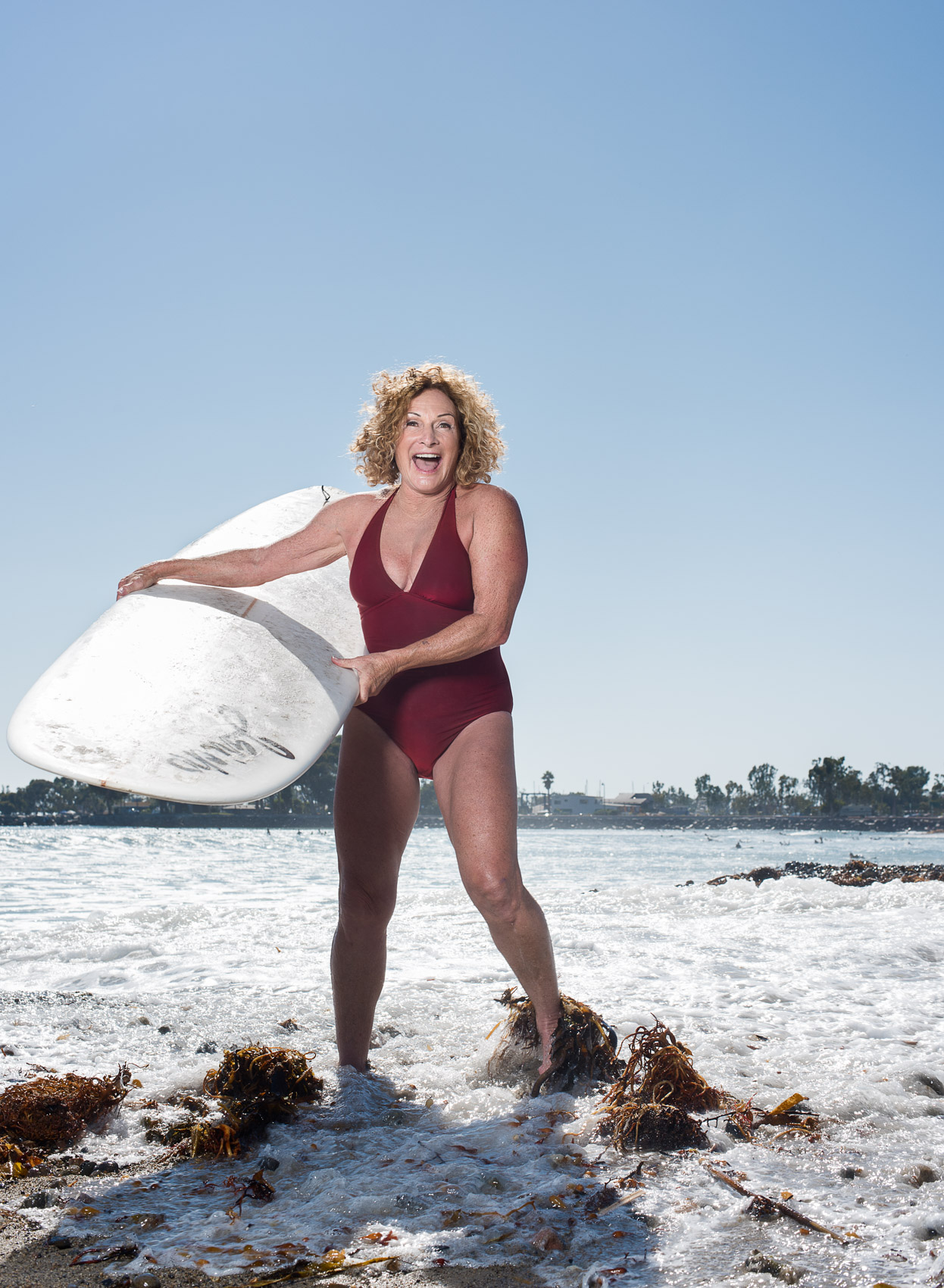 Senior surfer big wave surfing champion woman portrait in Doheny 