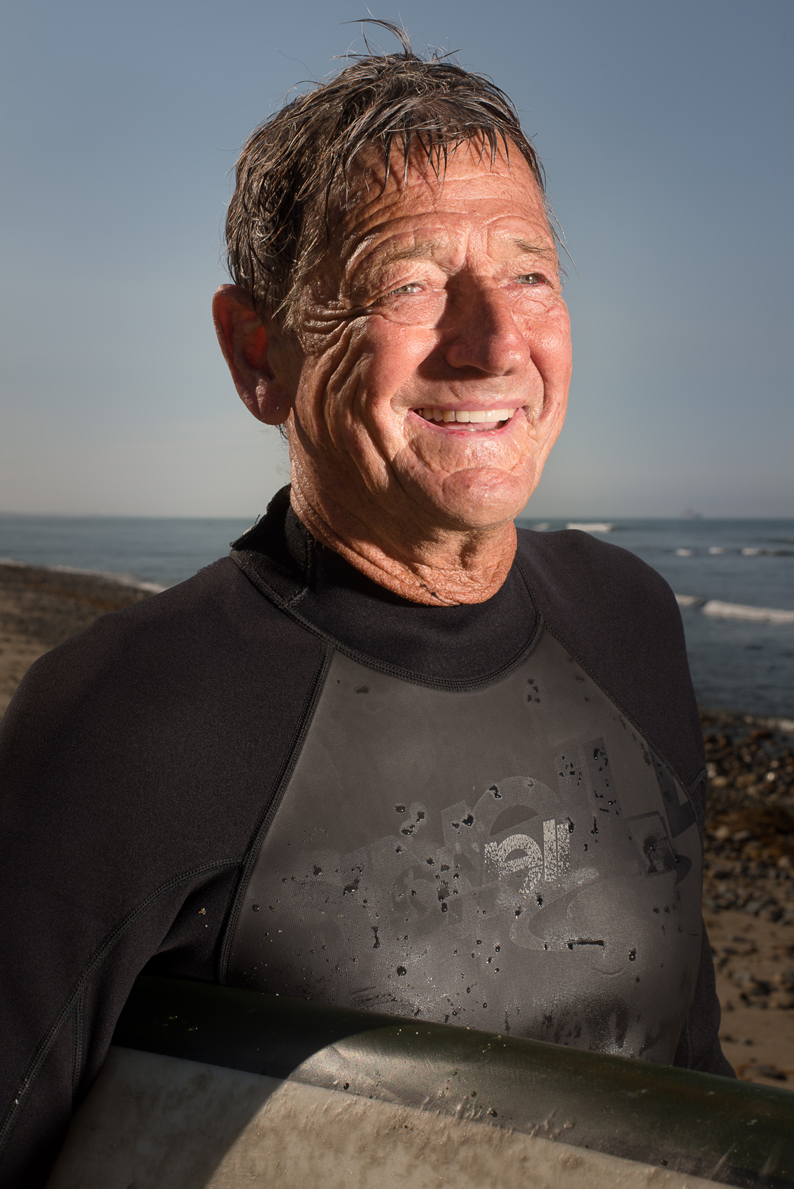 Senior surfer Elroy Lang portait on the beach at San Onofre State Beach, Calif.